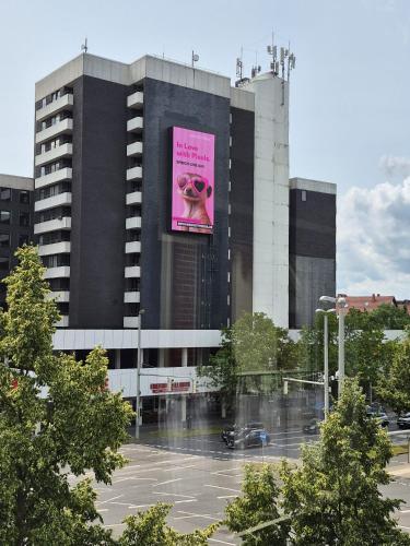 a large building with a large pink sign on it at Apartment No 3 in Braunschweig