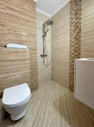 a bathroom with a toilet and a shower at Park suite in Burgas