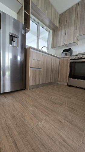 a kitchen with wooden cabinets and a stainless steel refrigerator at Relaxation House 