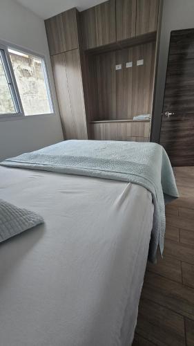 a bedroom with a large white bed and a window at Relaxation House 