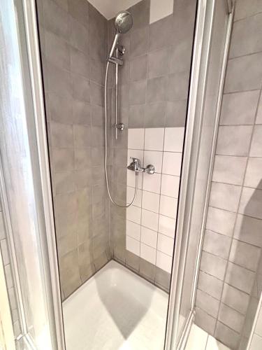a shower with a glass door in a bathroom at Franziskaner Suites #13 in Graz