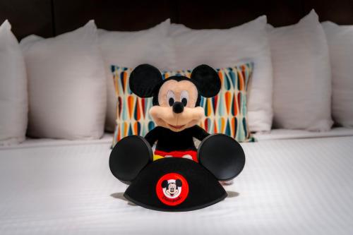 a stuffed mickey mouse sitting on a bed at Alpine Inn near Convention Center and the Park in Anaheim