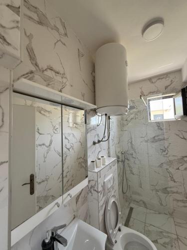 a bathroom with a toilet and a sink at Xhan Apartments in Ulcinj