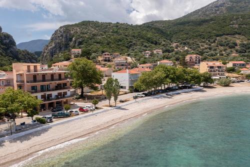 a view of a beach in a town with mountains at Flat on the sea in Póros Kefalonias
