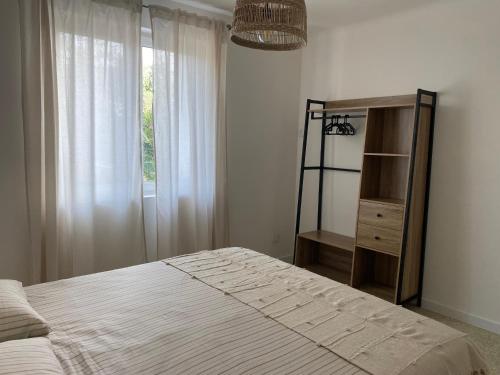 une chambre avec un lit, une commode et une fenêtre dans l'établissement La maison de Marinette, à Séguret