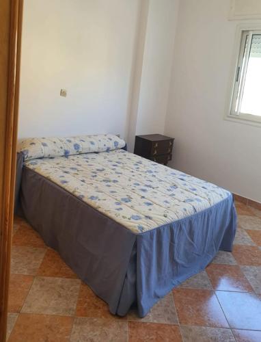 タンジェにあるAppartement Tanger 5の青い掛け布団が敷かれたベッドのある寝室