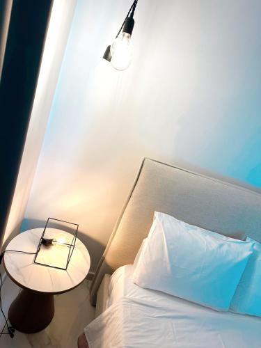 a bedroom with a bed with a table and a lamp at Luxury City Penthouse-Panoramic View-Near Unic in Nicosia