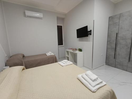 a bedroom with a bed with two towels on it at Le follie in Maddaloni