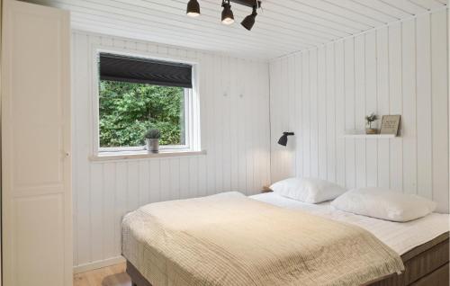 a bedroom with a bed and a window at 3 Bedroom Amazing Home In Silkeborg in Silkeborg
