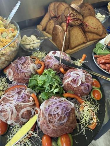 a tray of food with vegetables and other foods at Penzion na Lůkách in Horní Bečva