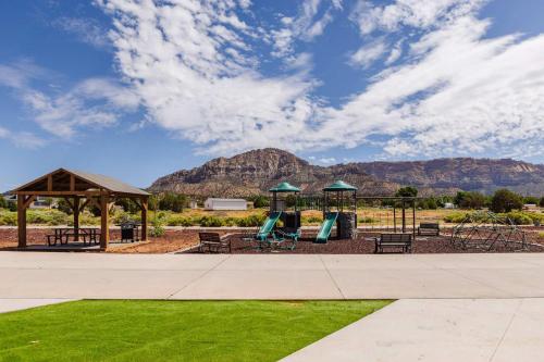a park with a playground with mountains in the background at Romantic Tiny home with private deck in Apple Valley