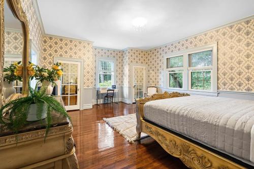 a bedroom with a bed and a table with flowers on it at WestWind Estate in Spartanburg