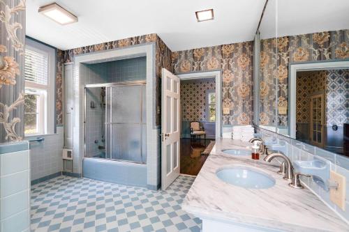 a bathroom with two sinks and a shower at WestWind Estate in Spartanburg