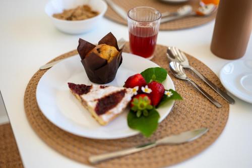 a plate of food with cake and strawberries on a table at Il Casale nel Parco in Ostuni