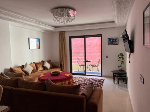 a living room with a couch and a table at Moga Appartment in Essaouira