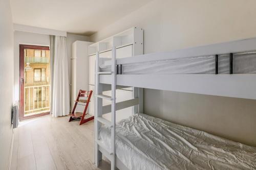 a bedroom with two bunk beds and a chair at Grand Hotel D3 G in Oostduinkerke