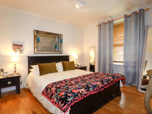 a bedroom with a large bed and a mirror at Sea View in St Austell