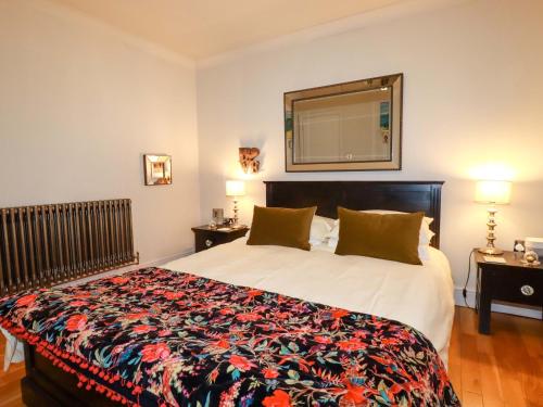 a bedroom with a large bed and a mirror at Sea View in St Austell