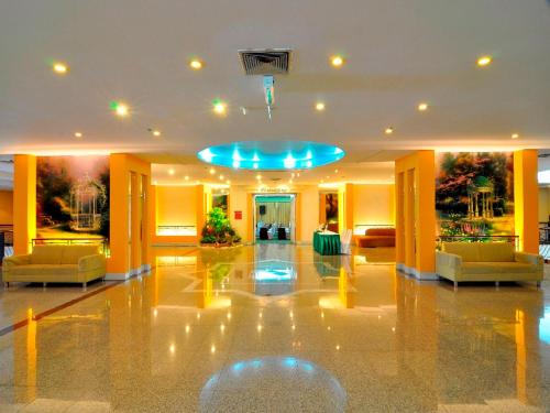 a lobby with two chairs and a blue ceiling at Duangtawan Hotel Chiang Mai in Chiang Mai