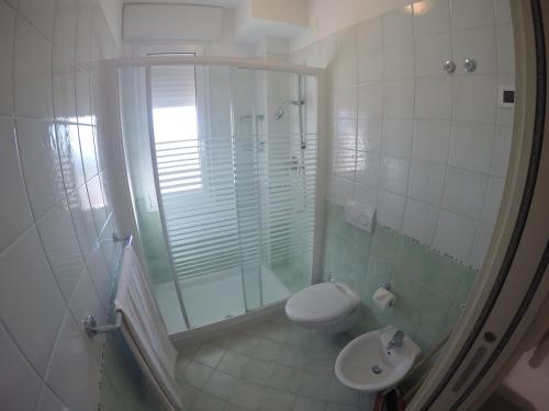 a bathroom with a shower and a toilet and a sink at Residence Zenith - Agenzia Cocal in Caorle