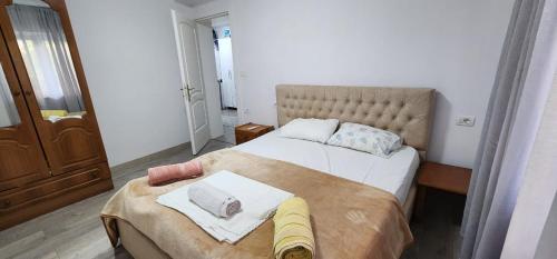 a bedroom with two beds with towels on them at A Story Worth Staying In in Shkodër