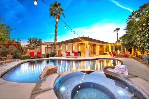 a house with a swimming pool in front of a house at NEW! All-Inclusive Luxury Villa - Walking Distance to Festivals and Polo Grounds in Indio