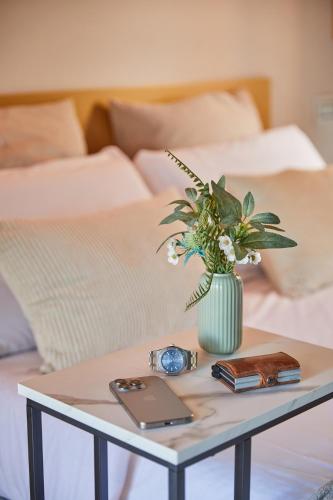 a table with a vase of flowers on top of a bed at Podere Raffanna Ecologic House in Massa e Cozzile