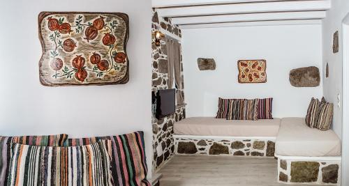 a room with two beds and a rug on the wall at Rodakas Rooms-Ariadni in Kondiás