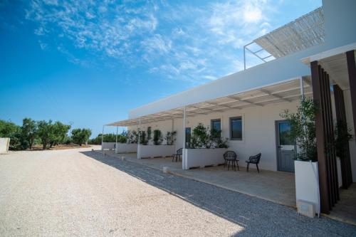 a white building with a solarium on top of it at Il Casale nel Parco in Ostuni