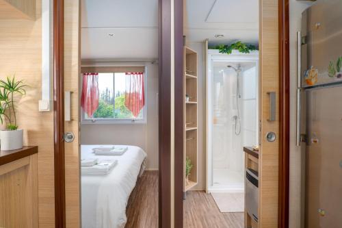 a small bathroom with a sink and a shower at Glamping Frog Farm in Foz do Sousa