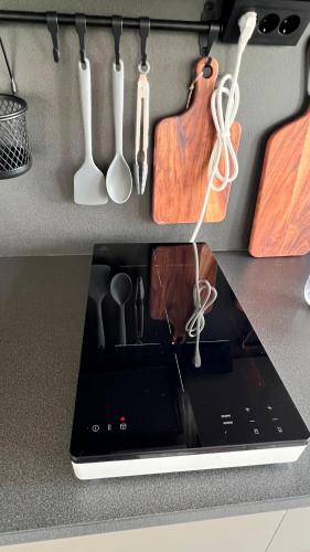 a laptop computer sitting on a counter with utensils at Villa Vinja in Ystad