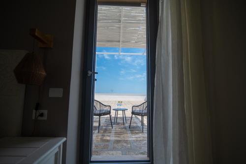 a door to a room with a view of the beach at Il Casale nel Parco in Ostuni