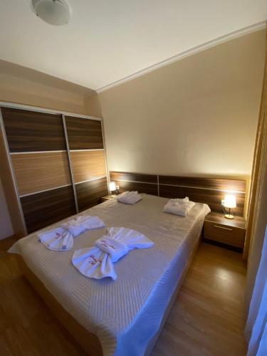a bedroom with a bed with towels on it at Marina Park OLIWIA in Sveti Vlas