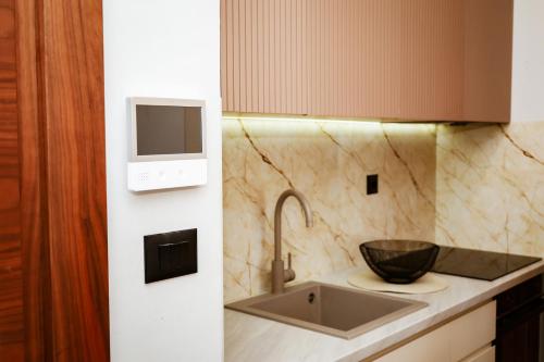 a kitchen with a sink and a microwave at VistaPool Residence Kotor in Dobrota