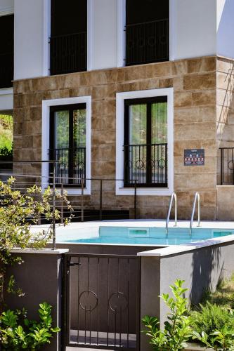 a swimming pool in front of a building at VistaPool Residence Kotor in Dobrota