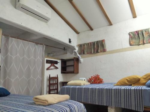 a room with two beds in a room at Hotel Hostal Teresa in Zipolite