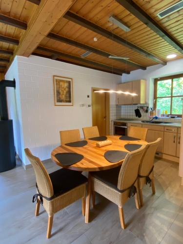 a kitchen with a wooden table and chairs at Ferienhaus Becker in Willingen
