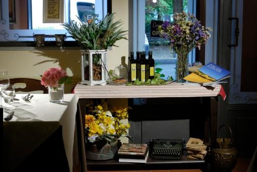 a table with bottles of wine and flowers on it at Locanda San Barnaba in Scarperia