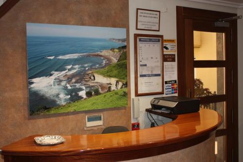 a room with a desk with a printer on a wall at Pensión Zumardi in Deba