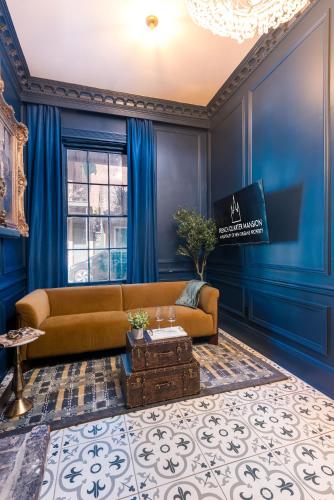 a living room with a couch and blue walls at French Quarter Mansion in New Orleans
