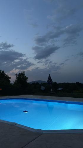 a large blue swimming pool at night at Kares house in Belgrade