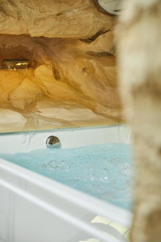 a bath tub filled with water in a room at Podere Raffanna Ecologic House in Massa e Cozzile