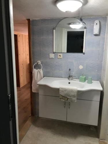 a bathroom with a white sink and a mirror at Guesthouse Dolunay in Ayder Yaylasi