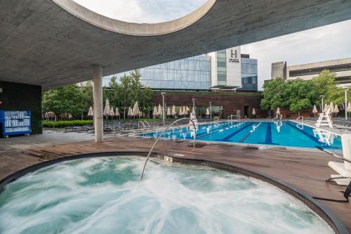 a large swimming pool with a water fountain at The Hotel & Athletic Club at Midtown in Chicago