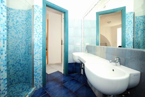 a bathroom with a white sink and a shower at Appartamenti Castello in Peschici