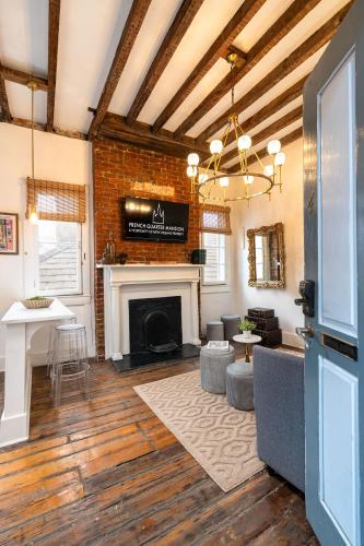 a living room with a fireplace and a table at French Quarter Mansion in New Orleans