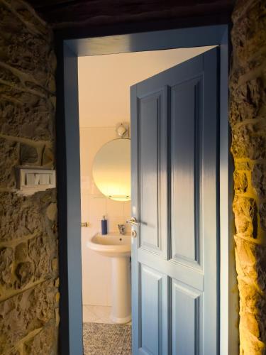 an open door leading to a bathroom with a sink at Villa Viera in Buzet