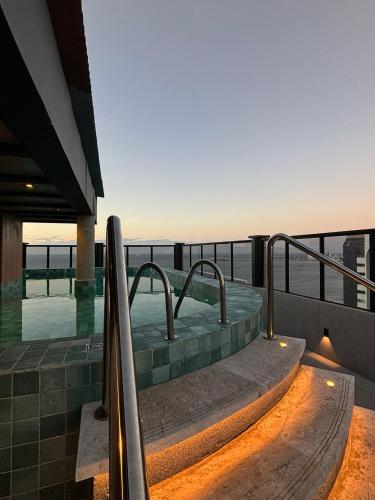 a hot tub on the balcony of a house at Hotel Brasil Tropical in Fortaleza