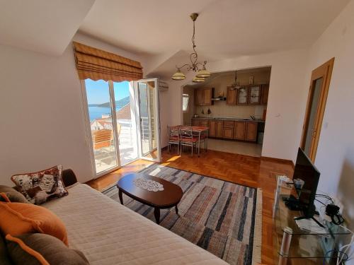 a living room with a couch and a table at Apartment Brace Grakalica 20b in Herceg-Novi