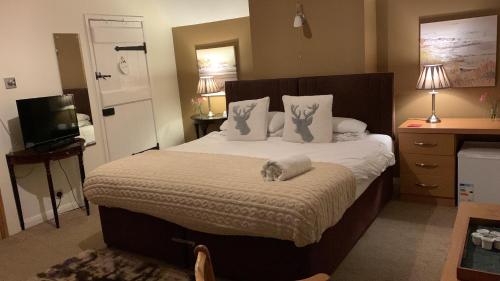 a bedroom with a bed with white sheets and pillows at Broadwalk9 in Coltishall